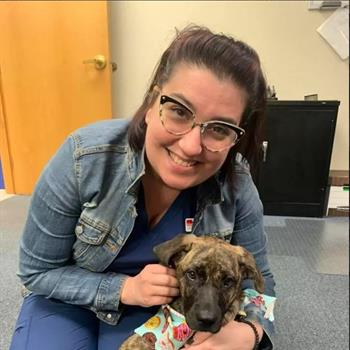 lady posing with a puppy